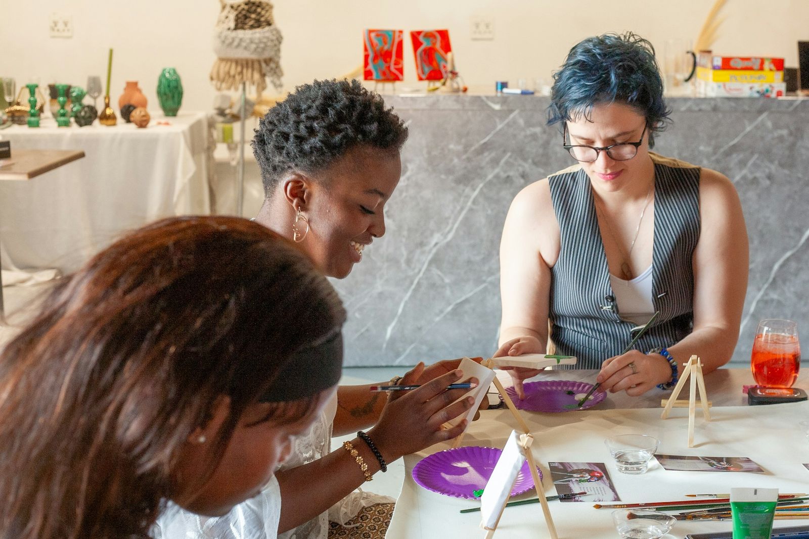 A group of Black women working on a craft project together at a table