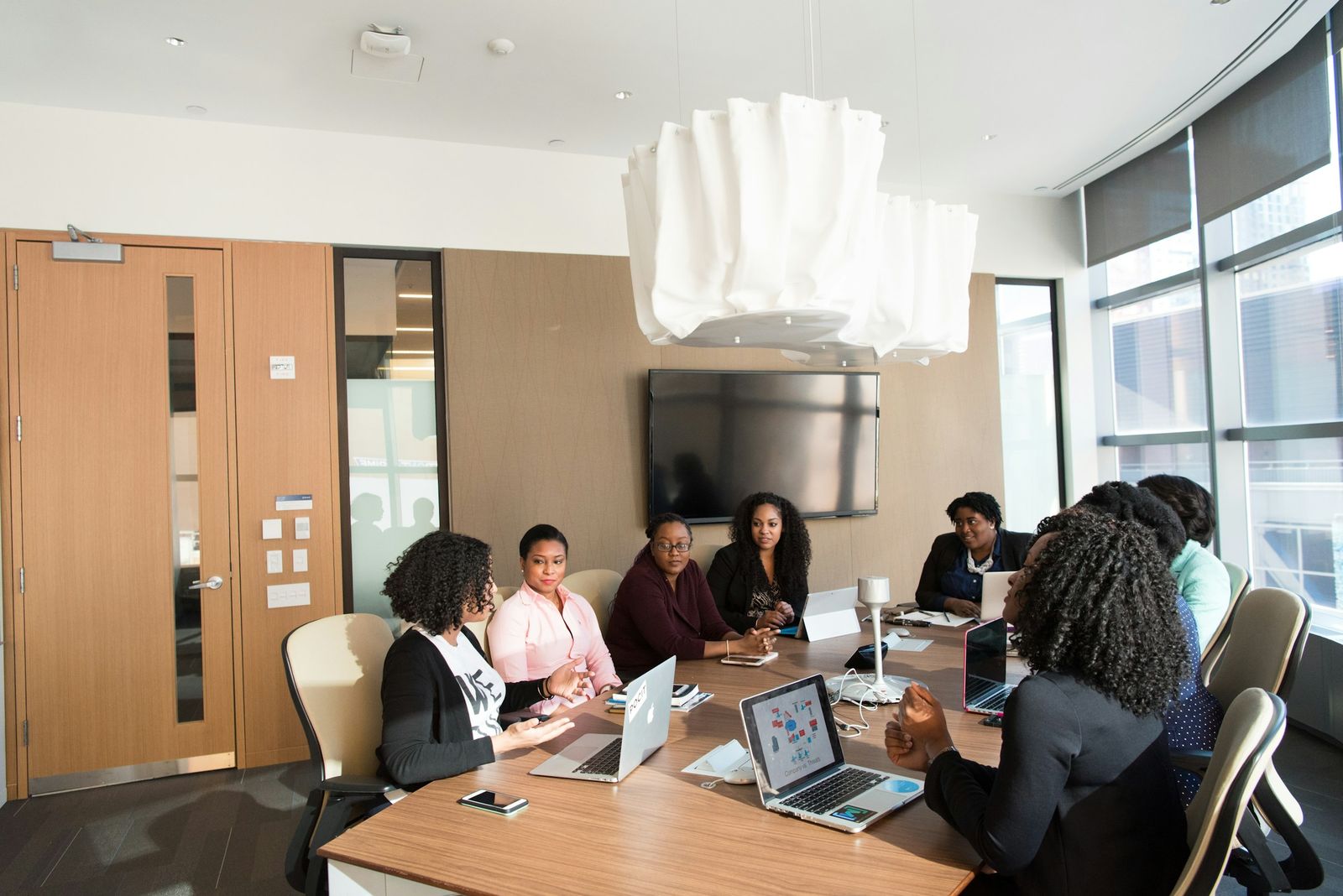 Board members seated around a boardroom table in discussion