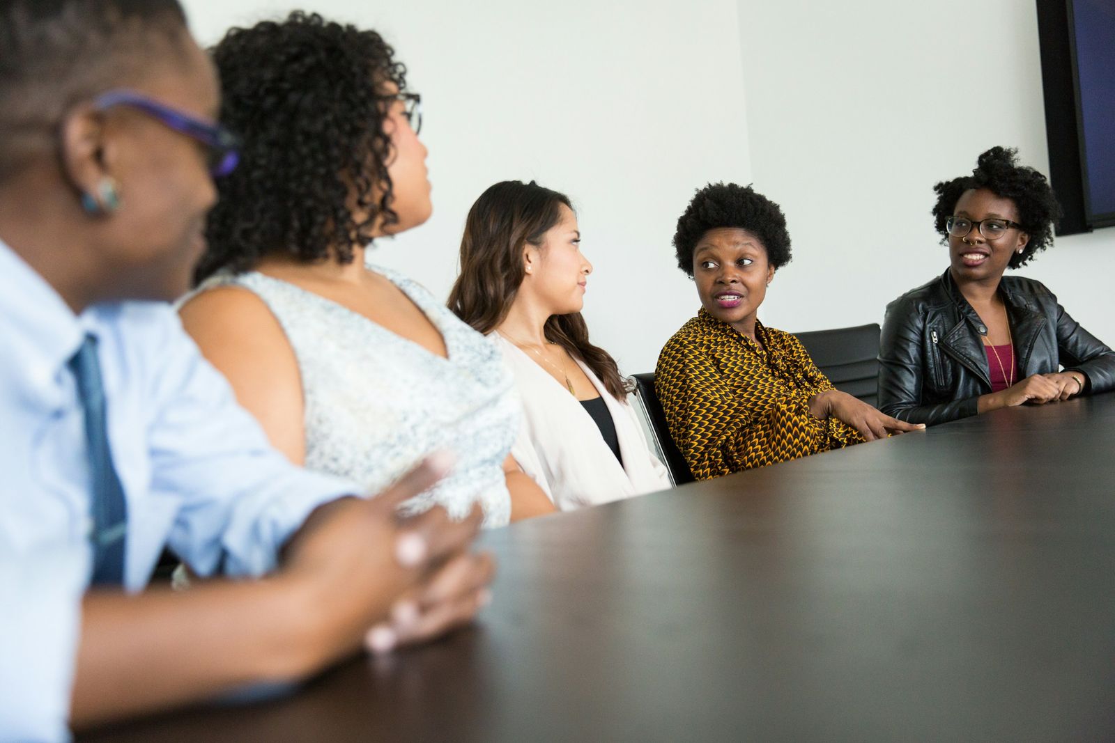 A group seated around a boardroom table in discussion